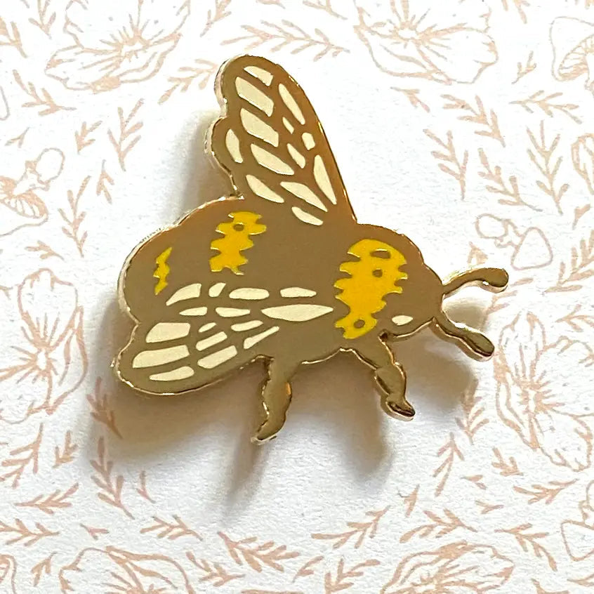 Limited Edition Mustard Beetle Bee Mirrored Pin showcasing an original illustration of a mustard beetle on a decorative backing card adorned with intricate patterns and the text "Mustard Beetle.