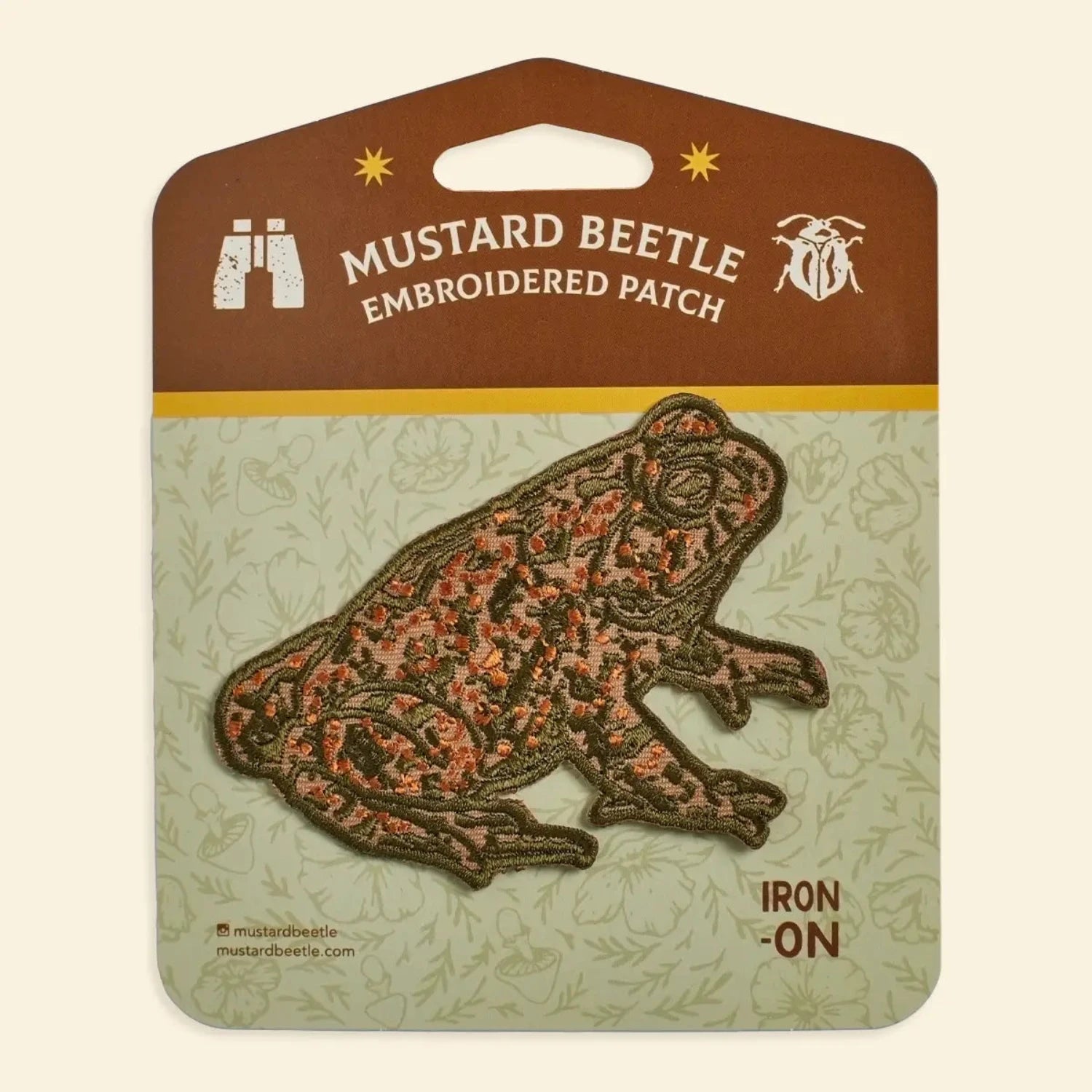 Brown & orange Mustard Beetle Toad iron-on patch on display card—perfect wildlife gift, embroidered nature accessory.