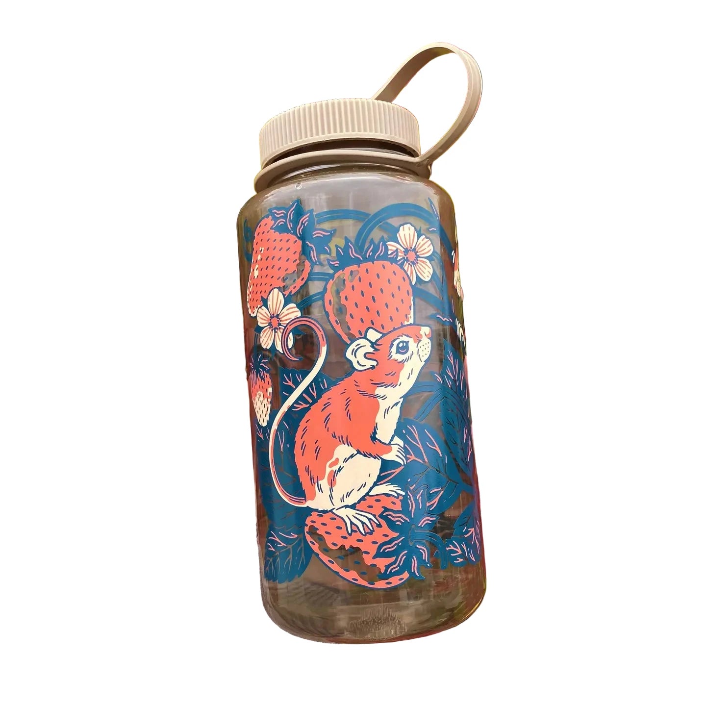 Hand holds Kate O’Hara Strawberries & Mice 32oz Nalgene Water Bottle – Cotton with red-green leafy plants in background.