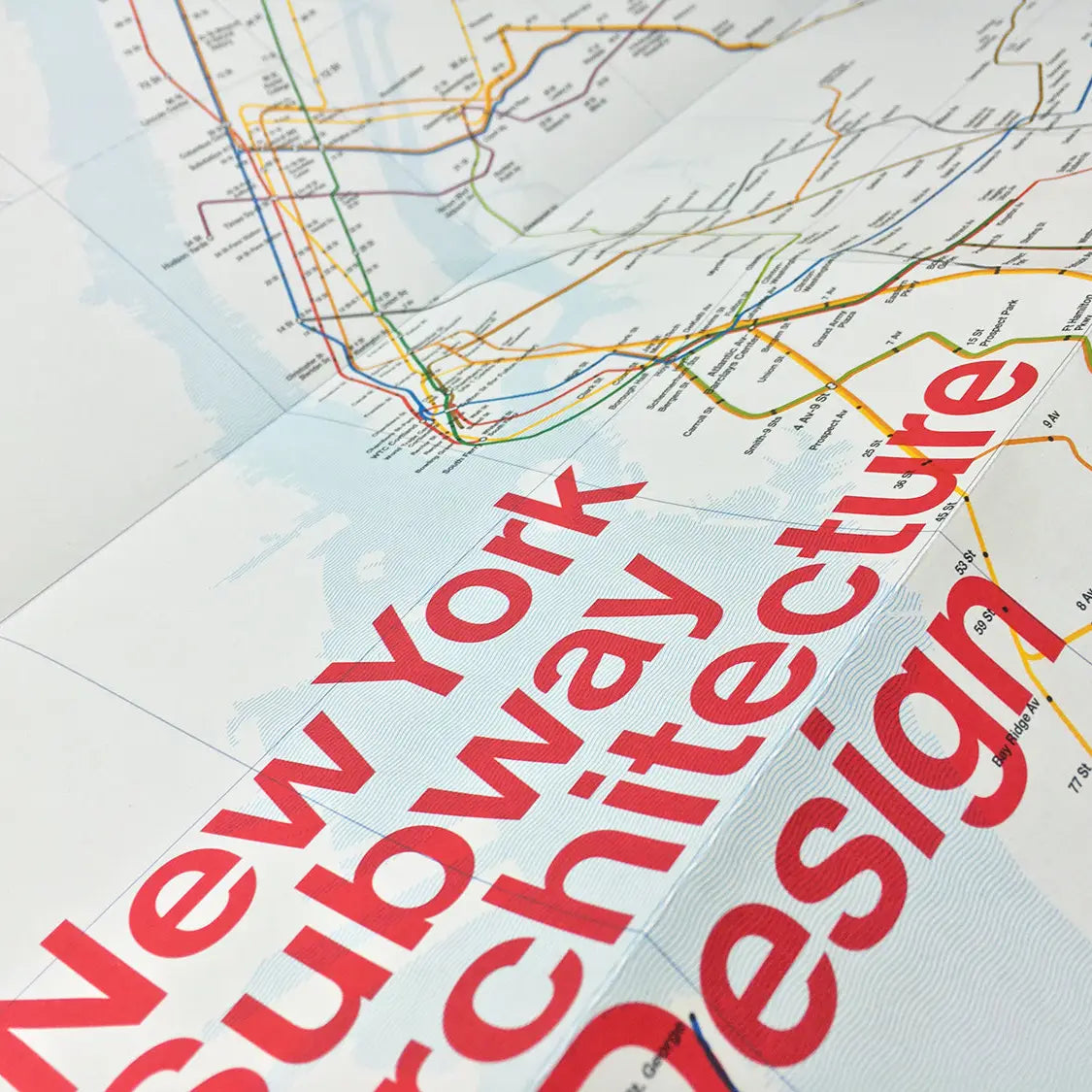 Cover of the "Blue Crow Media New York Subway Architecture Map," curated by Sandra Bloodworth for MTA New York City Transit, featuring a small preview of the subway map through a circular cut-out.