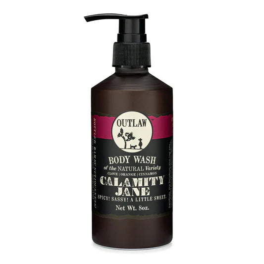 The Outlaw Soaps Body Wash 8oz - Calamity Jane features a convenient pump top and offers a distinctive fragrance blend of clove, orange, and cinnamon.