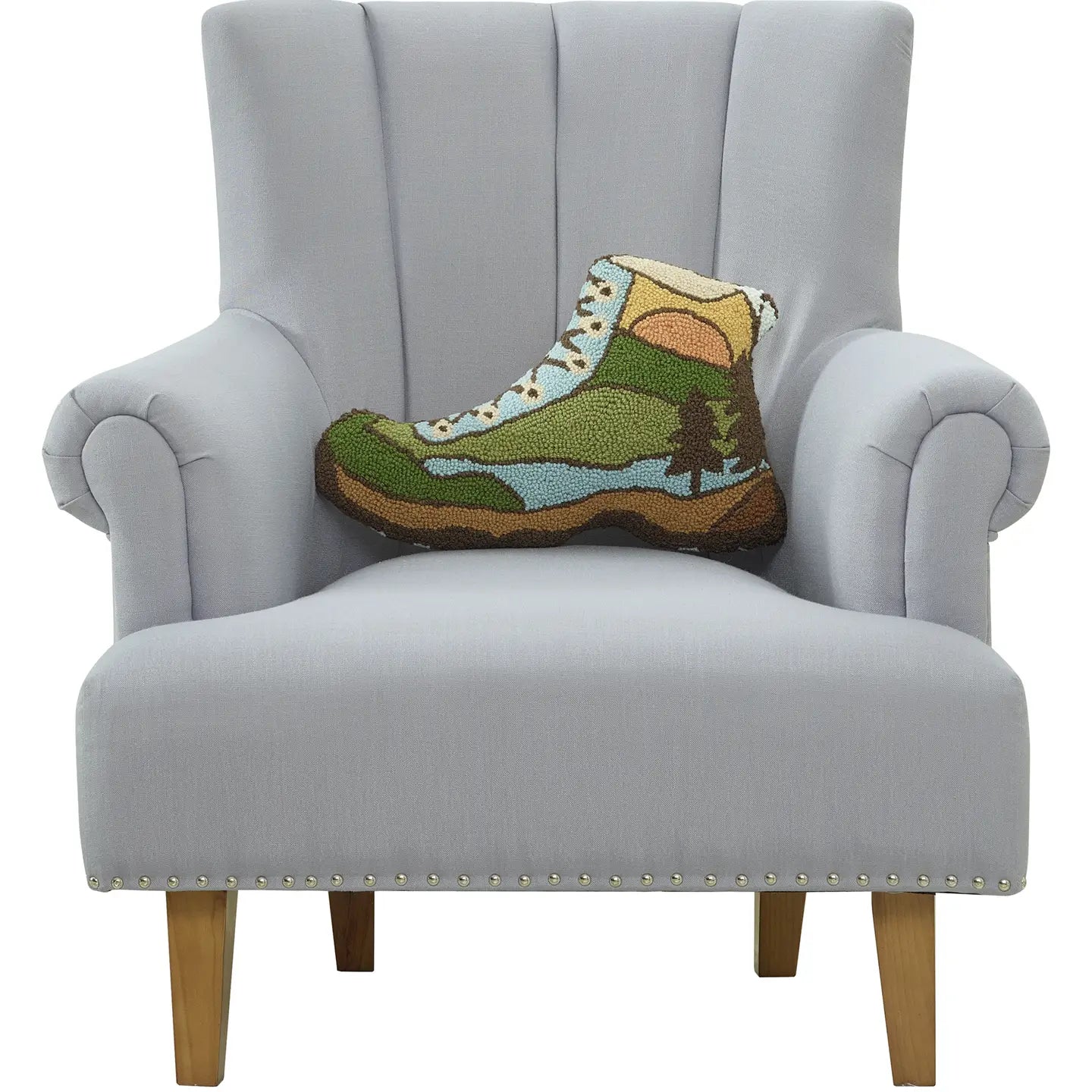 Light gray armchair with wooden legs and Peking Hiking Boot Wool Cushion, perfect rustic decor accent for cozy living rooms.