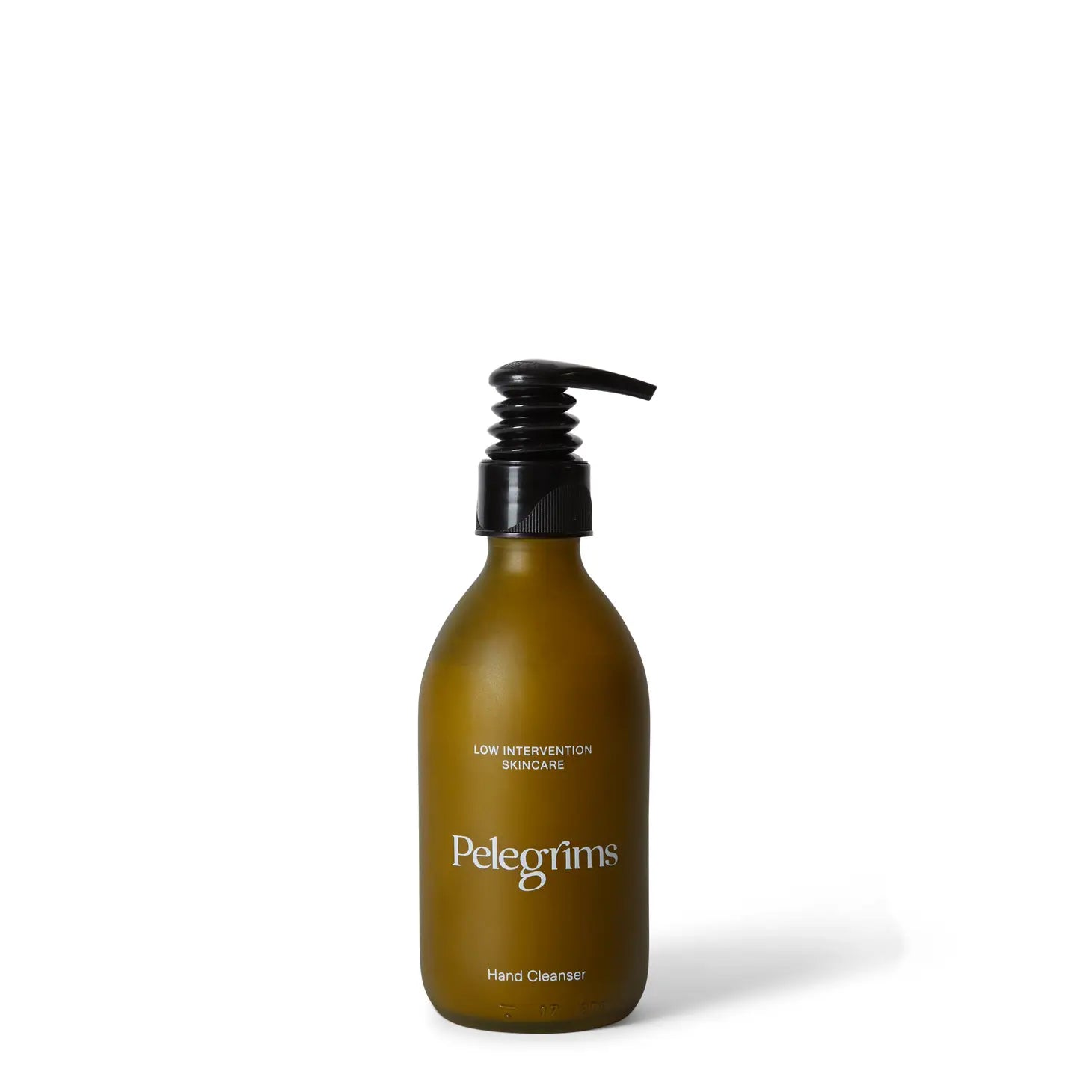 A brown bottle of Pelegrims Exfoliating Hand Cleanser, enriched with walnut shell and Ortega Grape Extract, is equipped with a black pump dispenser and displayed on a white background.