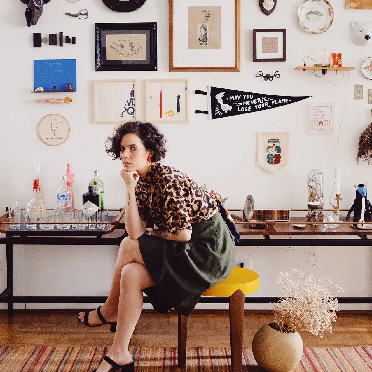 Woman on yellow stool, Oxford Pennants May You Never Lose Your Flame banner, home decor inspiration background.