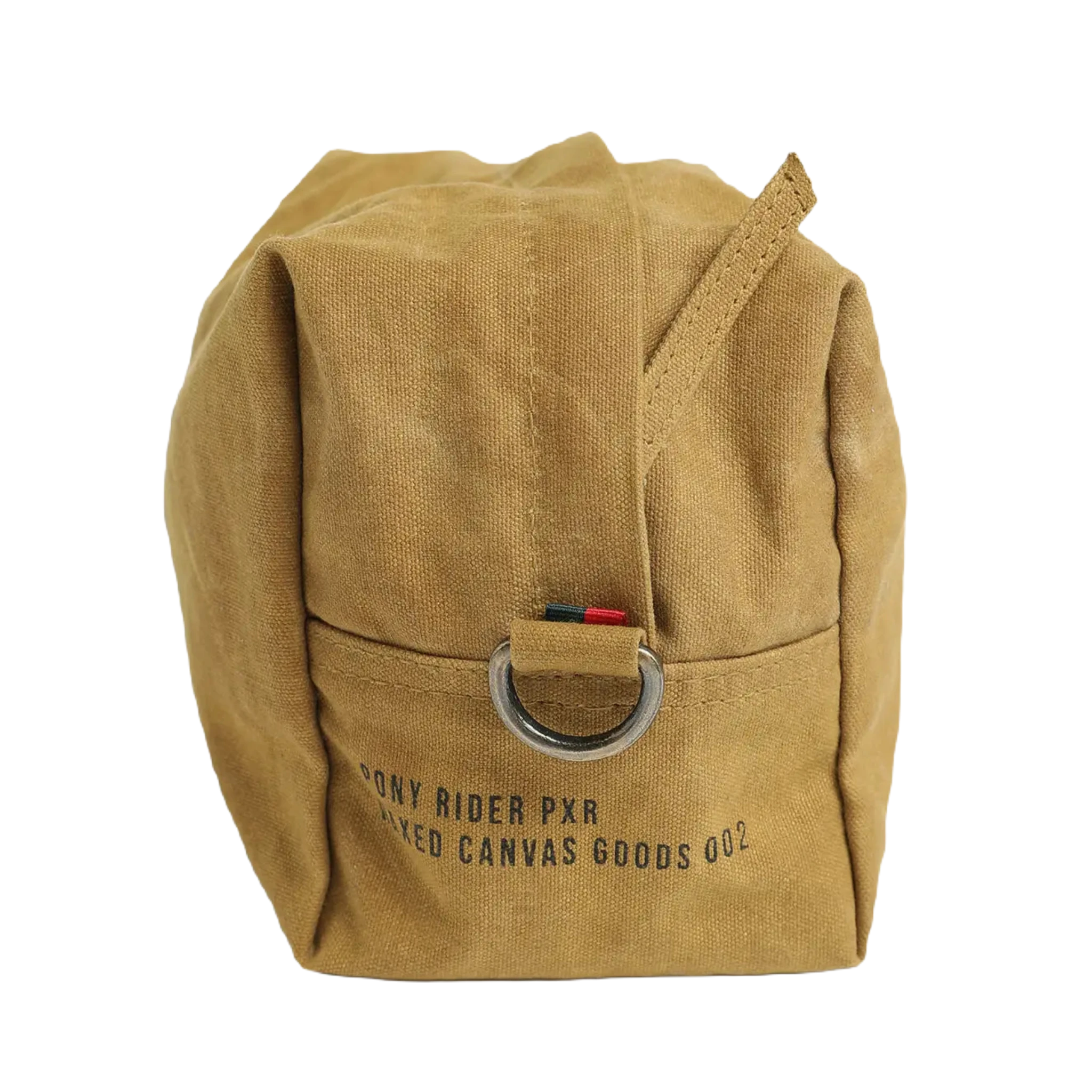 The Pony Rider Slow Road Waxed Canvas Toiletry Bag in Clay is a tan canvas grooming bag with a metal ring attached to a strap. It features the text "PONY RIDER PXR DYED CANVAS GOODS 002" printed on it. Made in India, this pouch comes with a handle zip closure for easy access and secure storage.