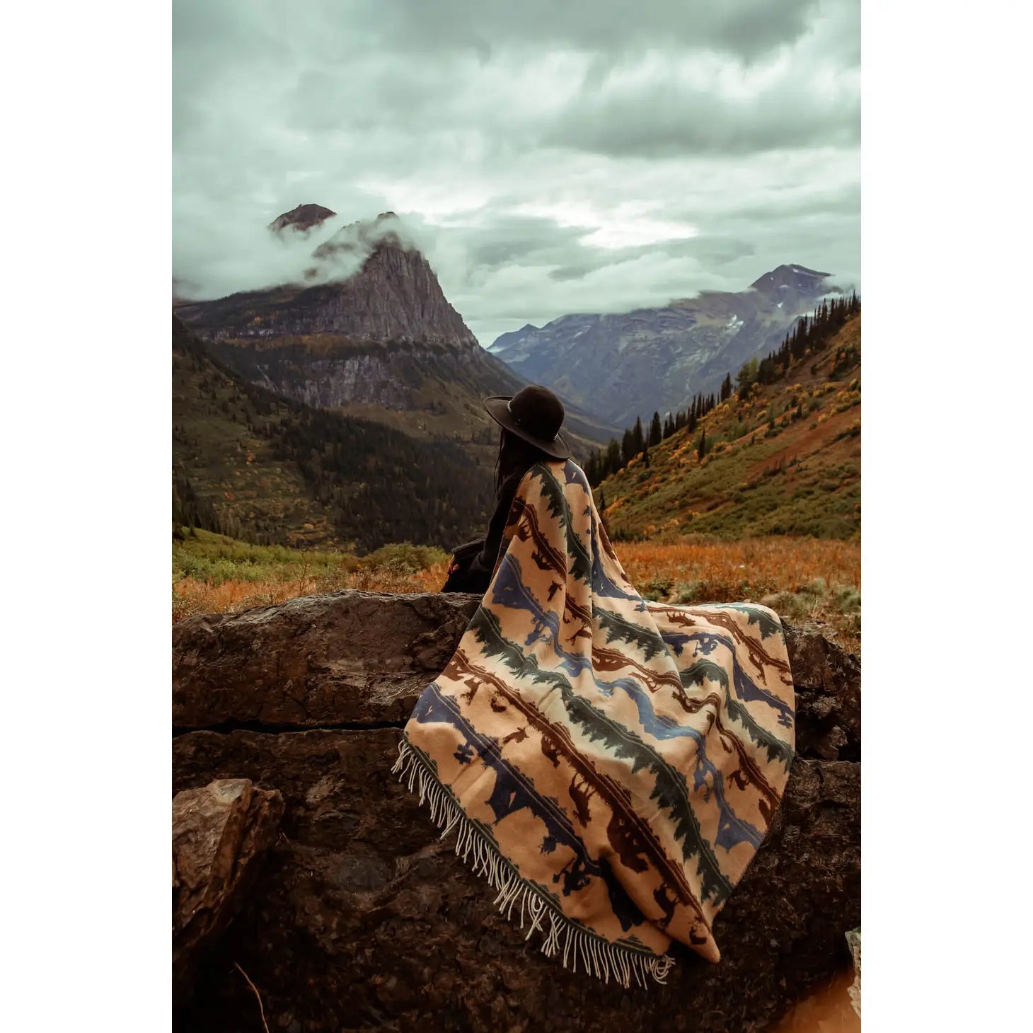 A Sackcloth & Ashes Smokey Bear Blanket - Smokey Dungaree, featuring woven rows with wilderness scenes of trees, mountains, bears, deer, and human figures in neutral tones.