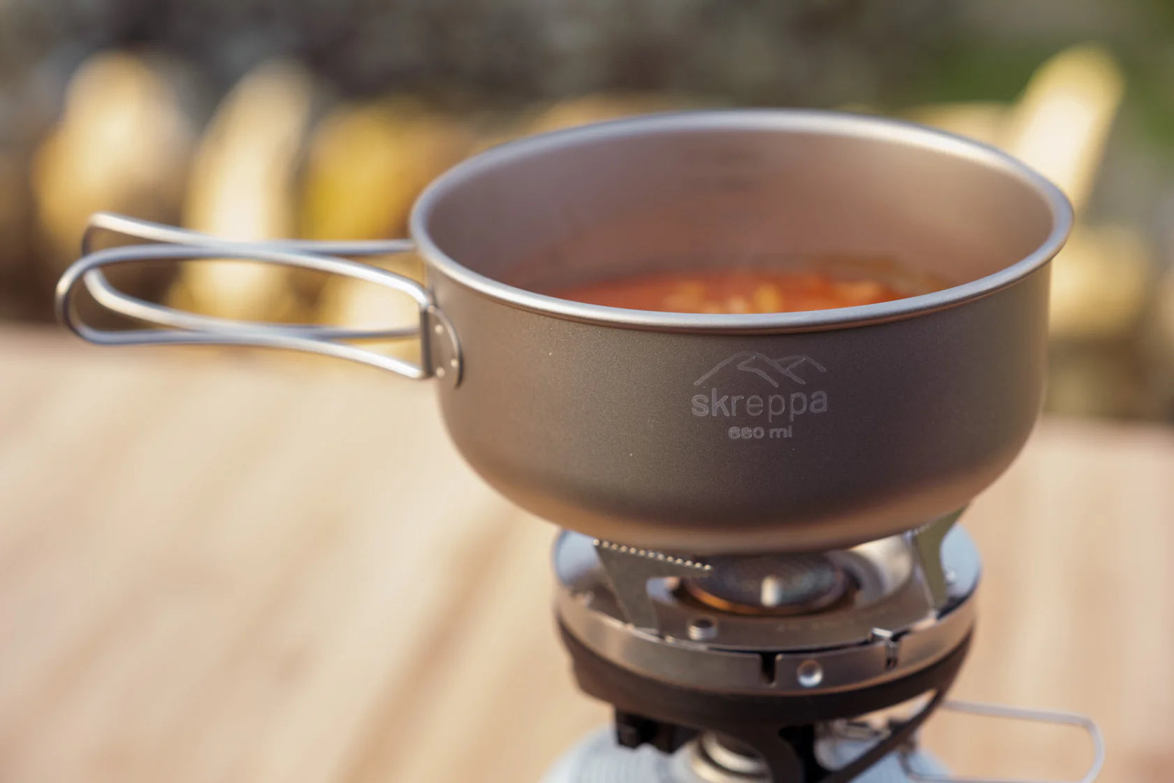 Skreppa 3 Piece Titanium Camping Cook Set pot on stove, food cooking inside—ultralight outdoor cookware for backpacking.