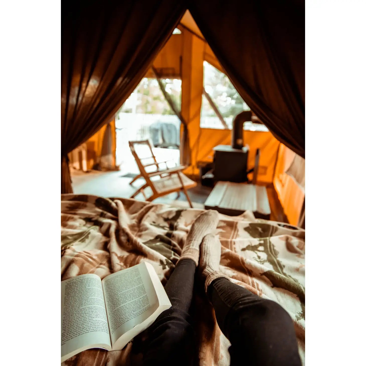The Sackcloth & Ashes Smokey Bear Blanket - Smokey Ranger features a stunning nature-themed design with silhouettes of trees, mountains, animals, and hikers in muted earth tones. This distinctive blanket not only supports wildfire prevention but is also made from recycled materials for an eco-friendly touch.