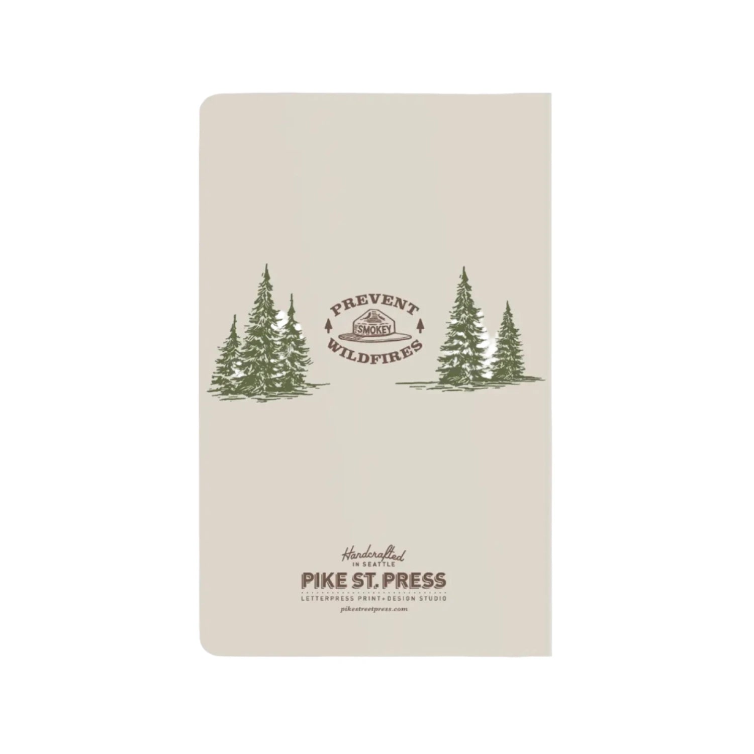 Image shows the back of a notebook with fir trees in green middle left and right with a smokey hat logo in the middle.