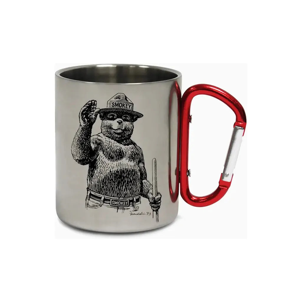 The Smokey Bear Carabiner Handle Mug - Waving Smokey is a silver mug that showcases an illustration of Smokey Bear wearing a ranger hat, featuring a vibrant red carabiner handle to promote wildfire prevention.