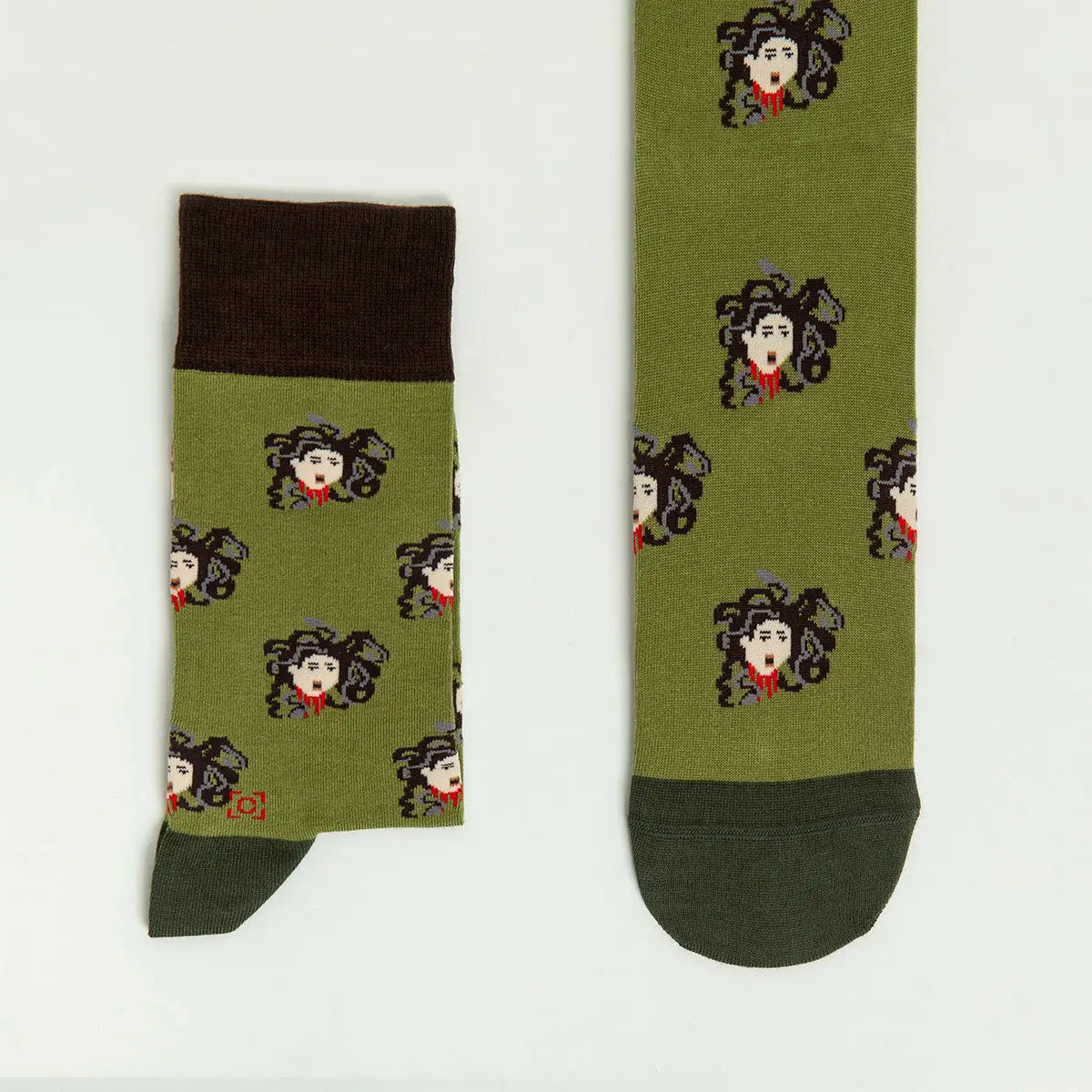 Sock Affairs Medusa Head Socks, Greek mythology-inspired, feature pixel art, green tones, and eco-friendly cotton for comfort.