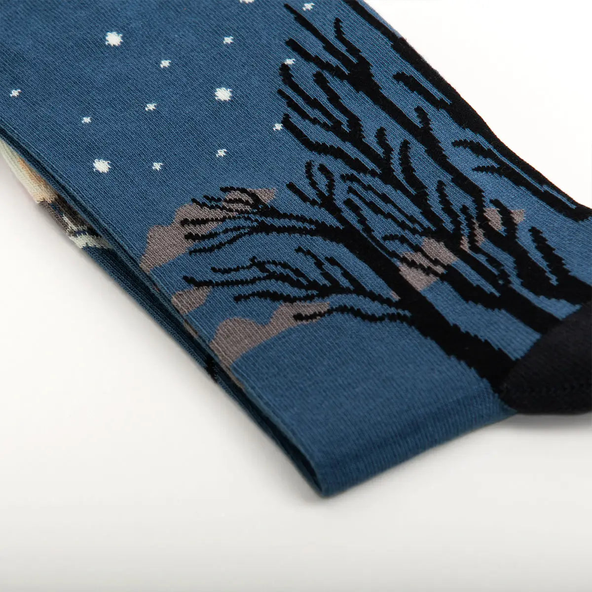 Sock Affairs Carnival Evening Rousseau socks with black trees, snowflakes, and surreal jungle motifs inspired by Rousseau art.