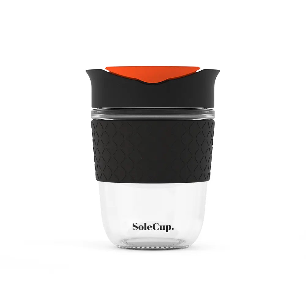 Eco-friendly Sole Cup Travel Mug, 12oz tempered glass, silicone grip, red lid—sustainable reusable coffee cup by Sole Cup.