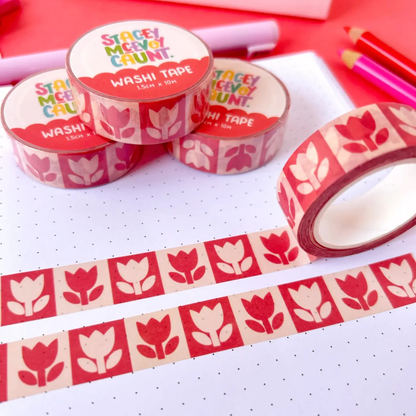 Stacey McEvoy Caunt Red Folk Tulips washi tape set on a dotted notebook, with colored pencilsâcraft supplies and stationery.