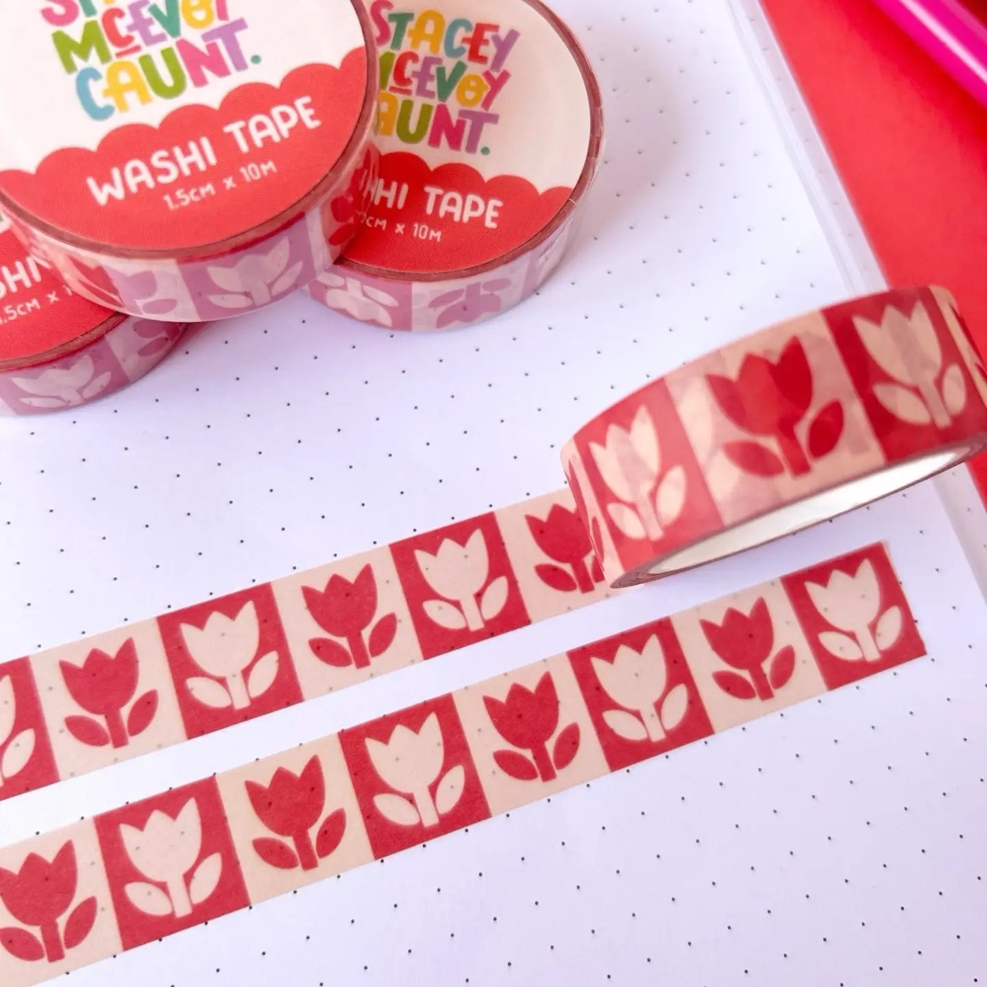 Stacey McEvoy Caunt Washi Tape Red Folk Tulips on dotted notebook, extra rolls behind. Decorative journaling supplies.