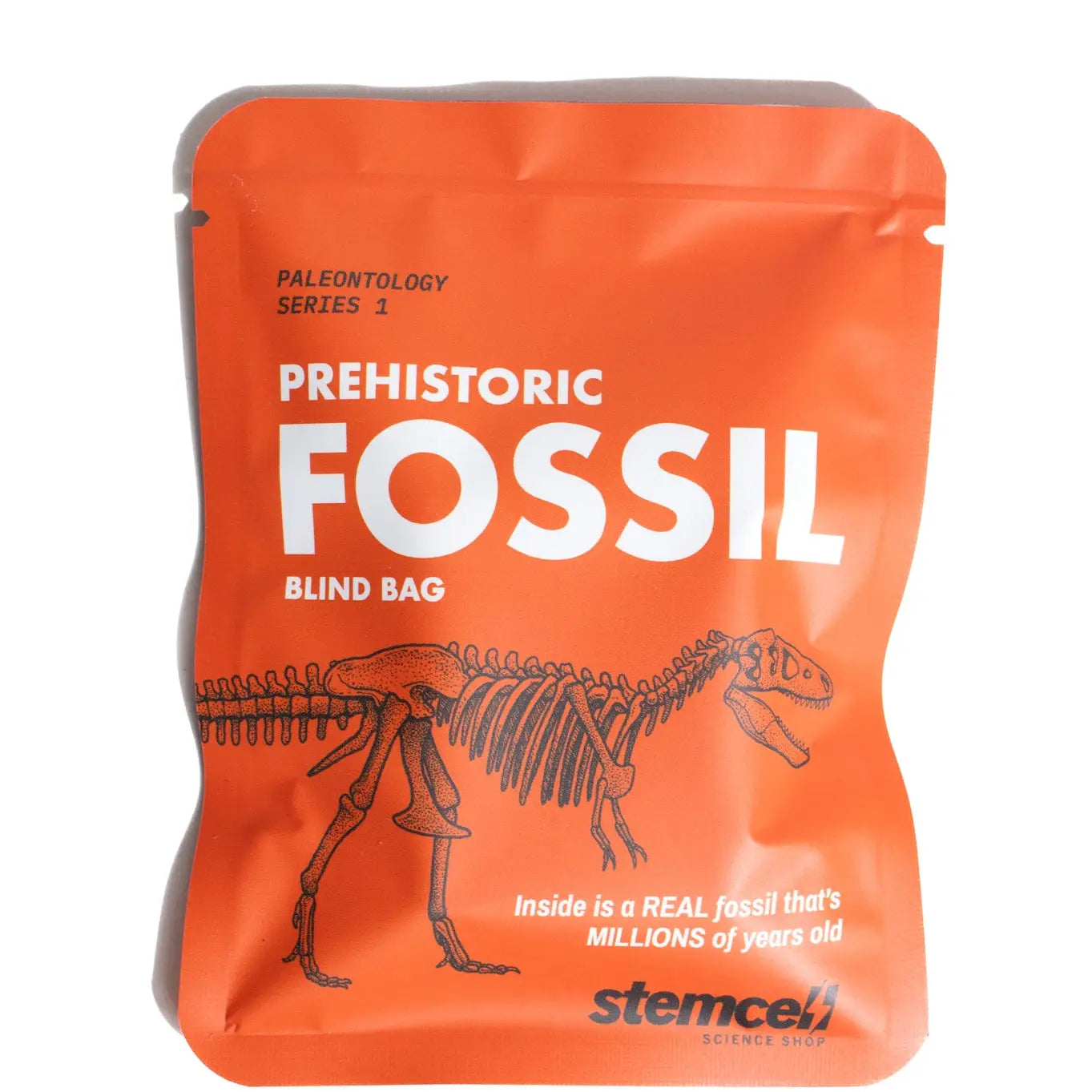 Stemcell Science Fossil Blind Bag with black dinosaur skeleton graphic, bold white text, and vibrant orange packaging design.