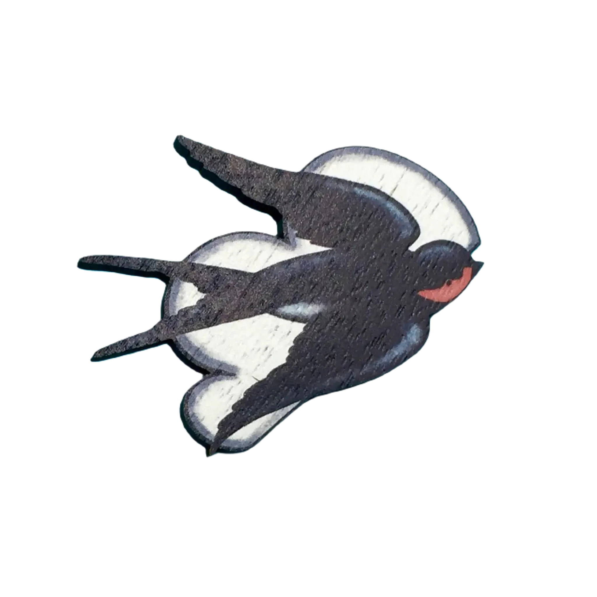 The Su Owen Swallows Brooch features a wooden pin in the shape of a flying swallow, with black and white wings and a red neck, crafted from sustainable walnut by Su Owen, set against a bright blue background.