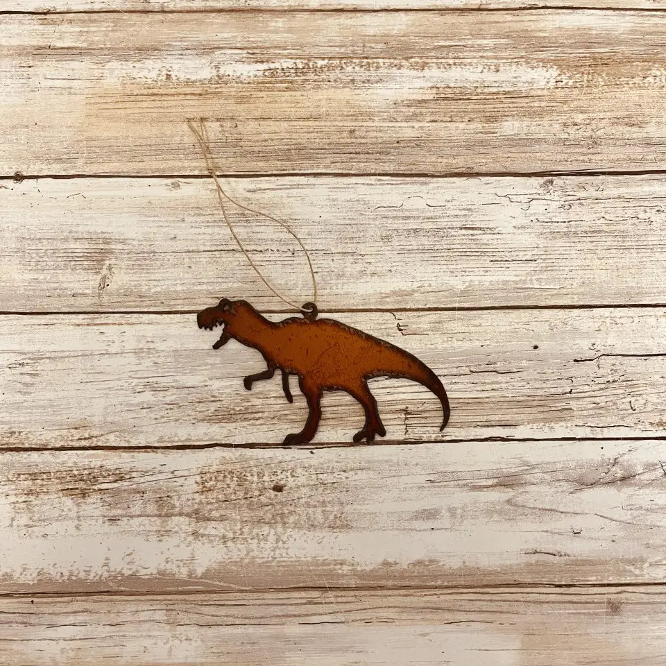 Universal Ironworks T-REX Hanging Decoration suspended by string on white wooden background; dinosaur wall or home decor.