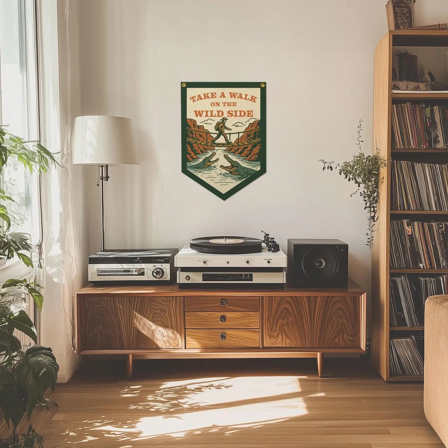 Mid-century cabinet with record player, speaker, lamp; Benoit’s Take A Walk On The Wild Side felt banner hanging above.