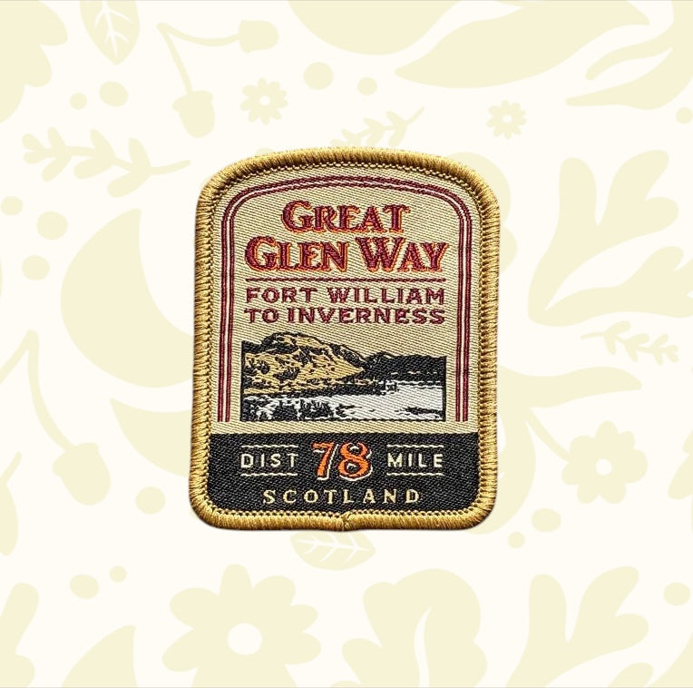 Great Glen Way Patch by The Adventure Patch Company on wood, commemorates this iconic Scottish Highlands hiking trail badge.