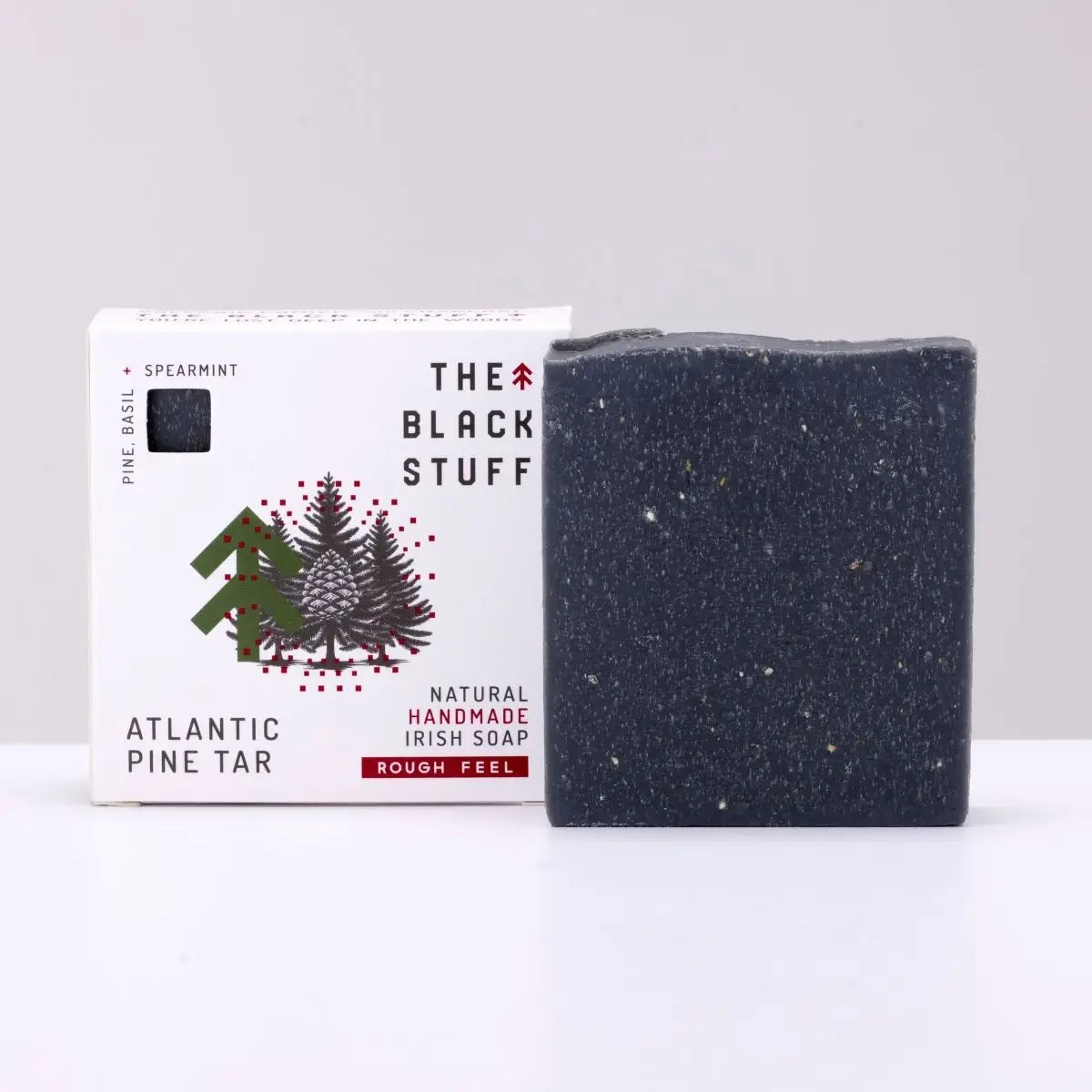 Square bar of The Black Stuff Soap - Atlantic Pine Tar beside box, premium natural Irish soap for men, branded The Black Stuff.