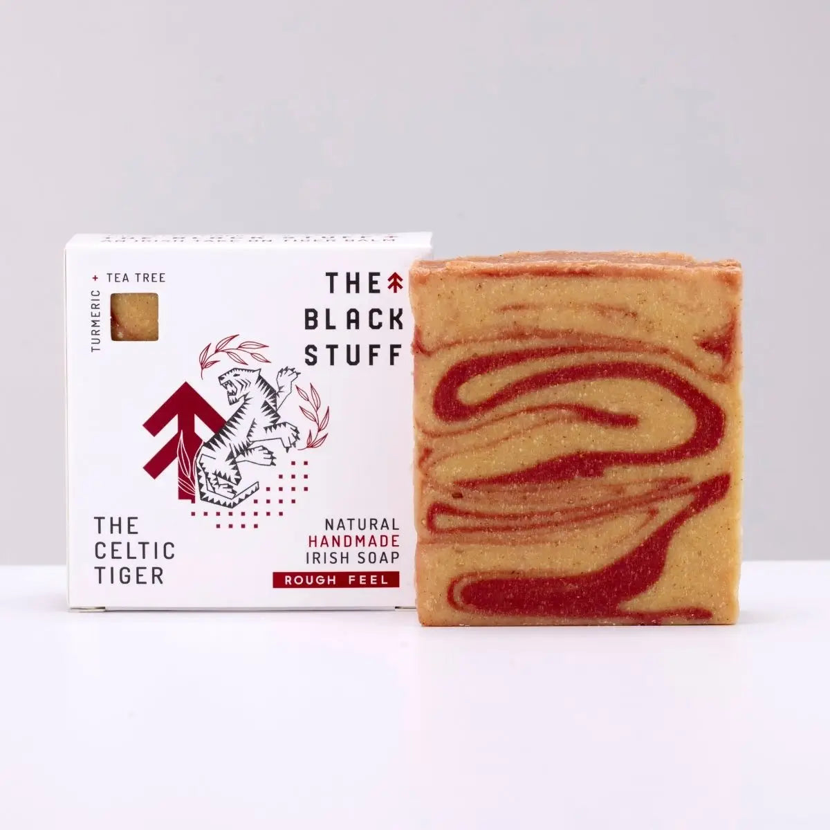 The Black Stuff Soap - The Celtic Tiger bar with red swirls, eco-friendly, natural ingredients, beside branded box.
