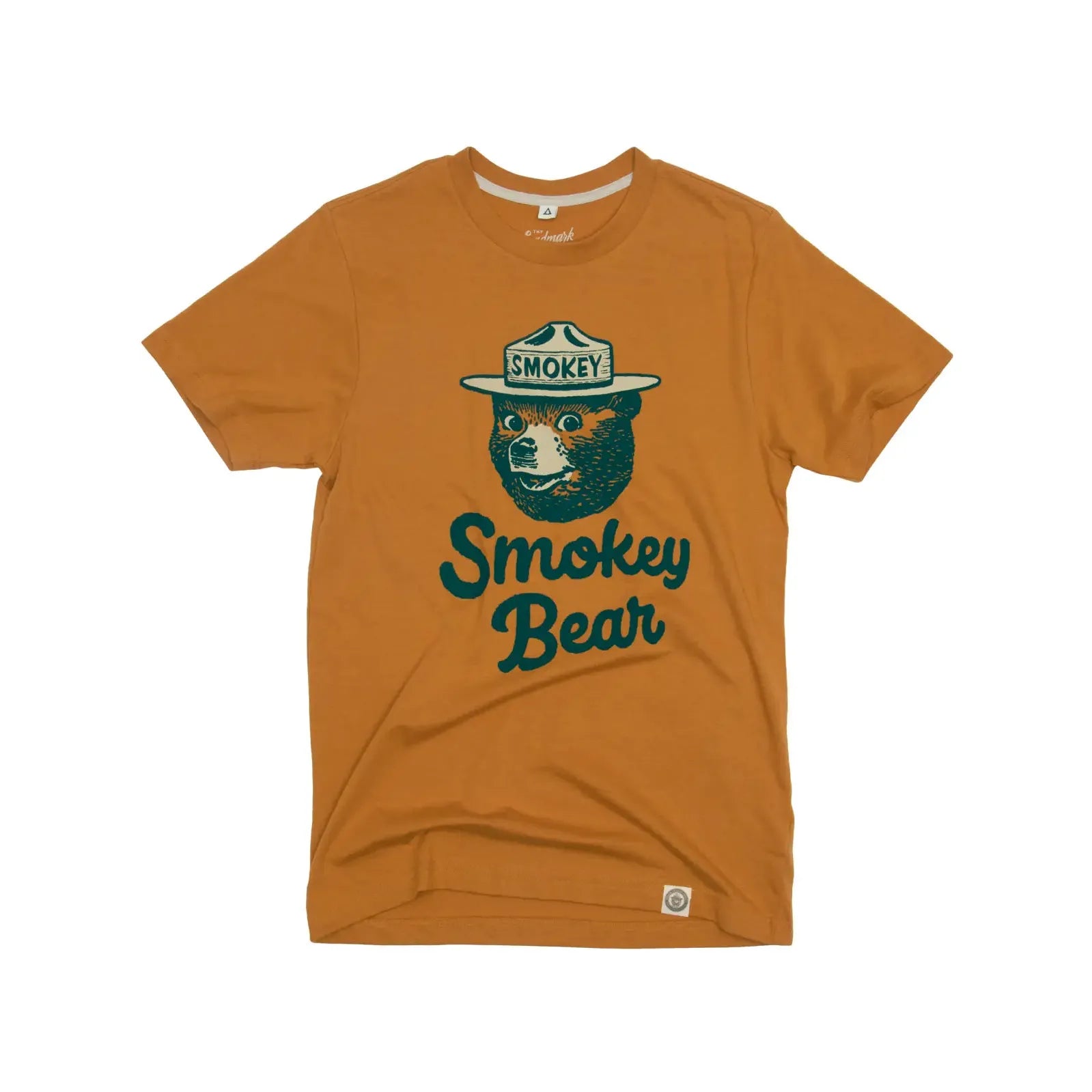 The Landmark Project Heritage Smokey Bear T-Shirt - Sundial is an orange T-shirt featuring a drawing of Smokey Bear wearing a hat, with vintage colors and the text "Smokey Bear" written in green below the image. This sustainably made shirt merges classic style with environmental consciousness.