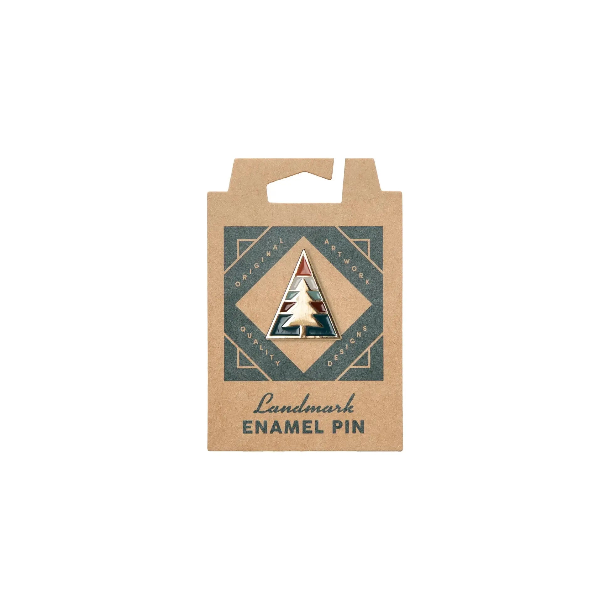 A triangular enamel pin of a pine tree on a brown cardboard backing card labeled "The Landmark Project Ponderosa Pin," showcasing a touchstone of America's favorite destinations.
