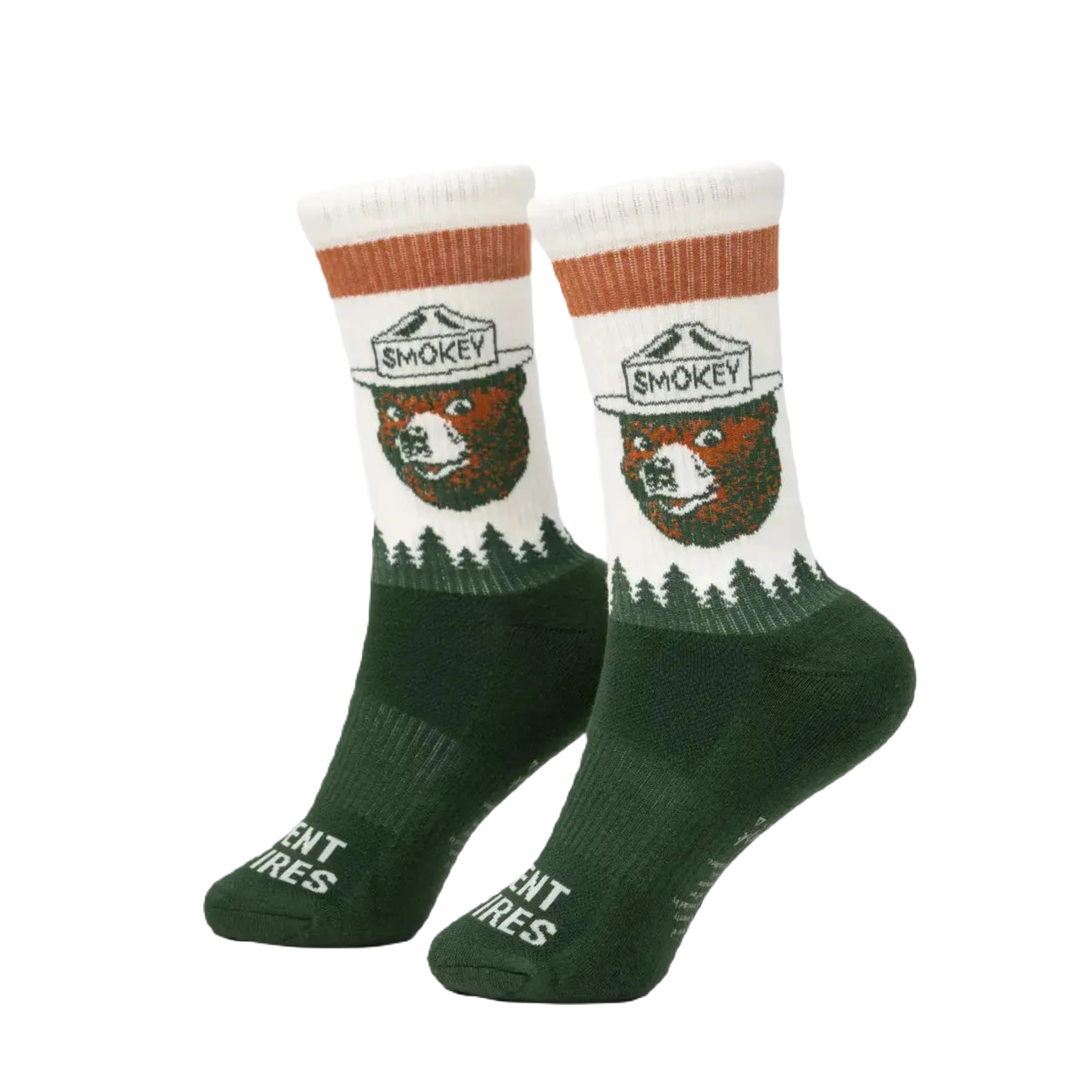 Close-up of The Landmark Project Smokey Bear Socks, crafted from green and white organic cotton, showcasing Smokey Bear in a ranger hat. The soles of the socks feature the phrase "Prevent Wildfires" alongside Smokey's logo.