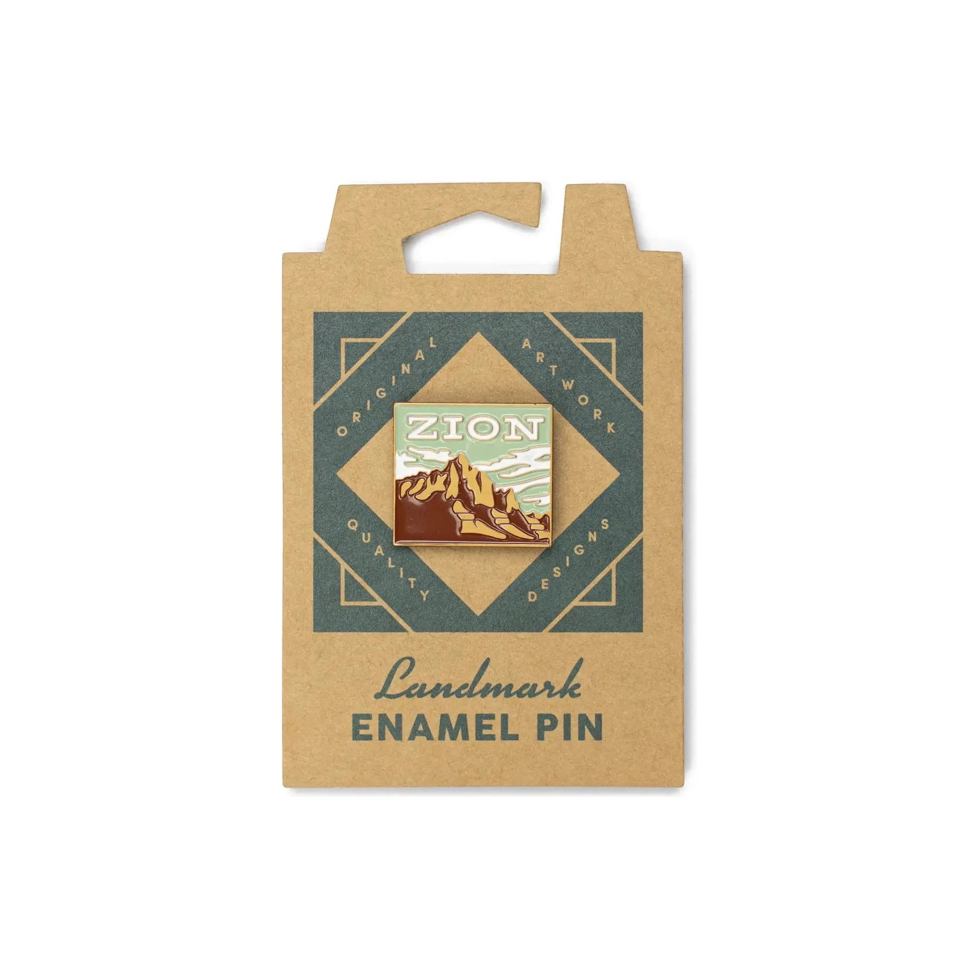 The Landmark Project Zion Pin is an enamel pin featuring a mountain landscape, attached to a cardboard backing with the text "Landmark Enamel Pin" and packaged sustainably.