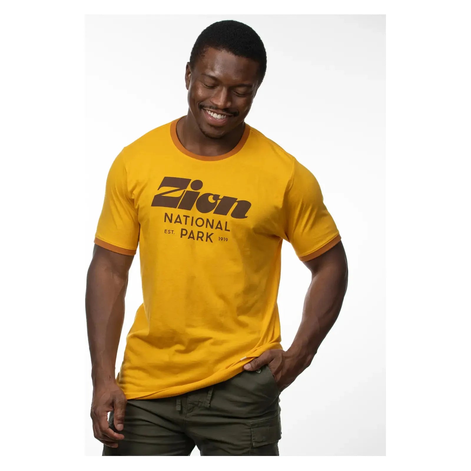 The Landmark Project Zion Script Type T-Shirt in yellow, featuring brown trim and bold brown text that reads "Zion National Park Est. 1919" on the front.