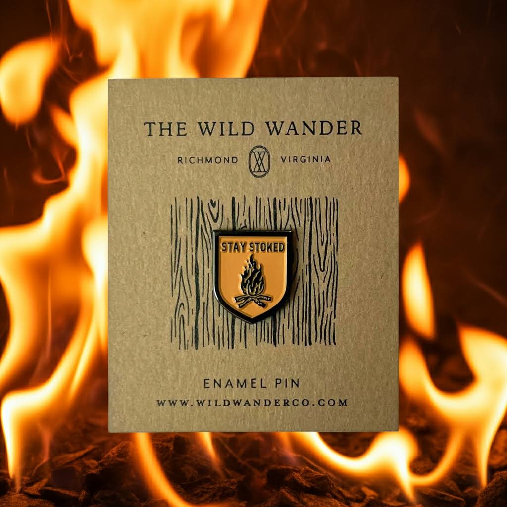 Forager Provisions LTD Stay Stoked enamel pin featuring a campfire design on a branded backing card against fire