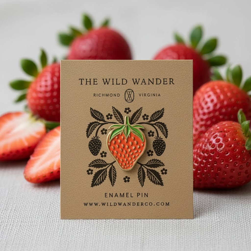 Forager Provisions LTD strawberry enamel pin on illustrated kraft card surrounded by fresh strawberries.