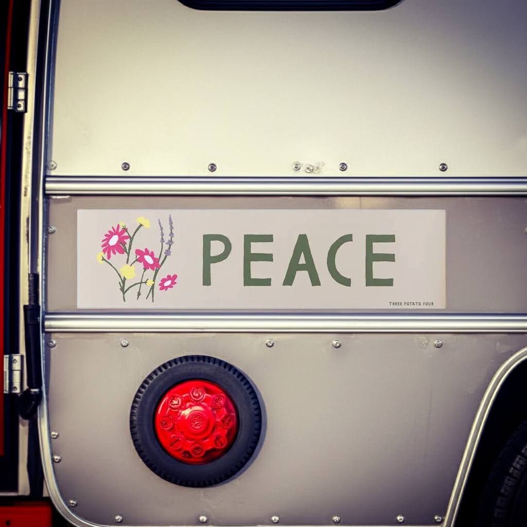 Forager Provisions LTD Three Potato Four Peace camper van magnet with floral design on a vintage metal trailer