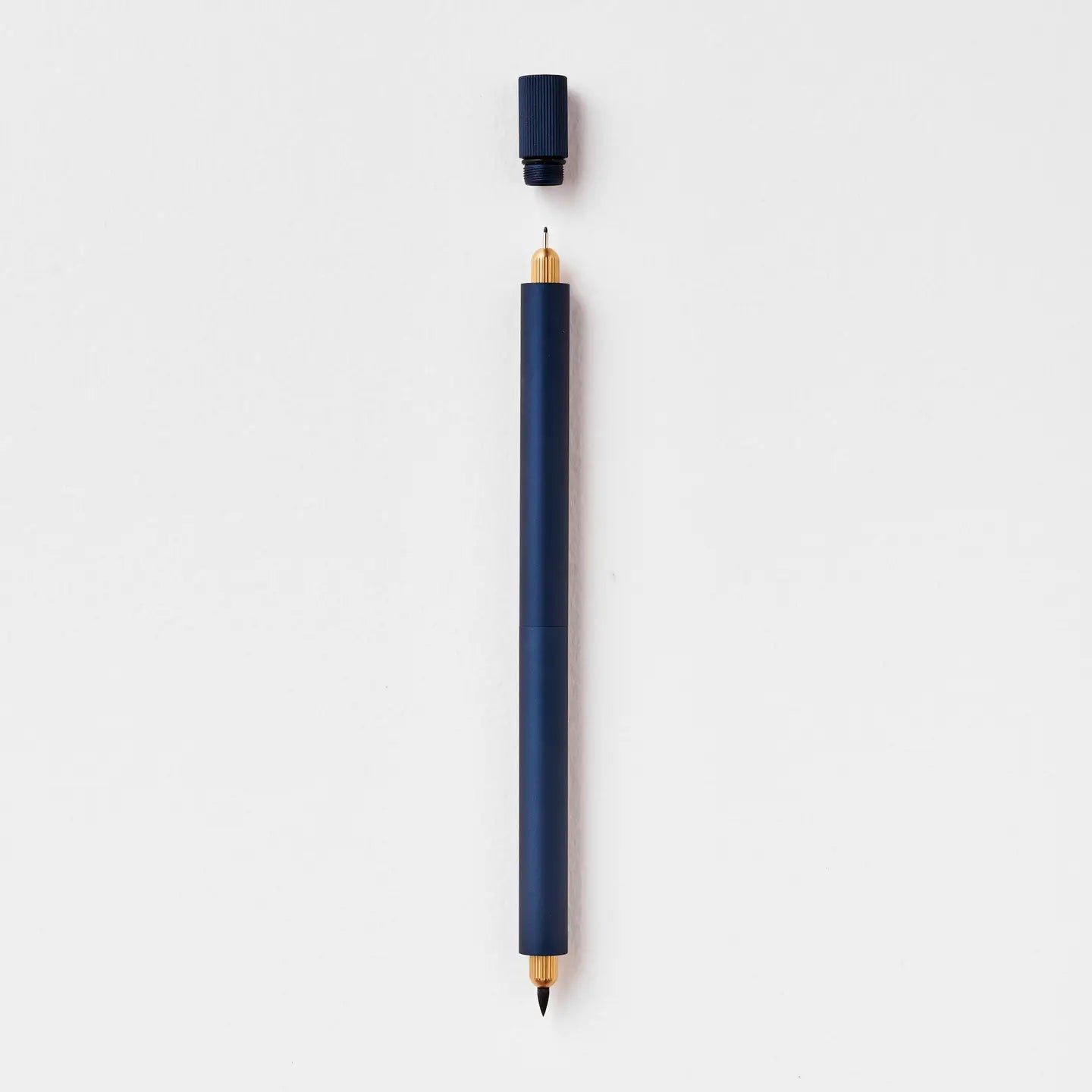 Tom’s Studio Lumos Pro Duo Midnight Pen uncapped, nib up, cap above, displayed on clean white background for writing lovers.