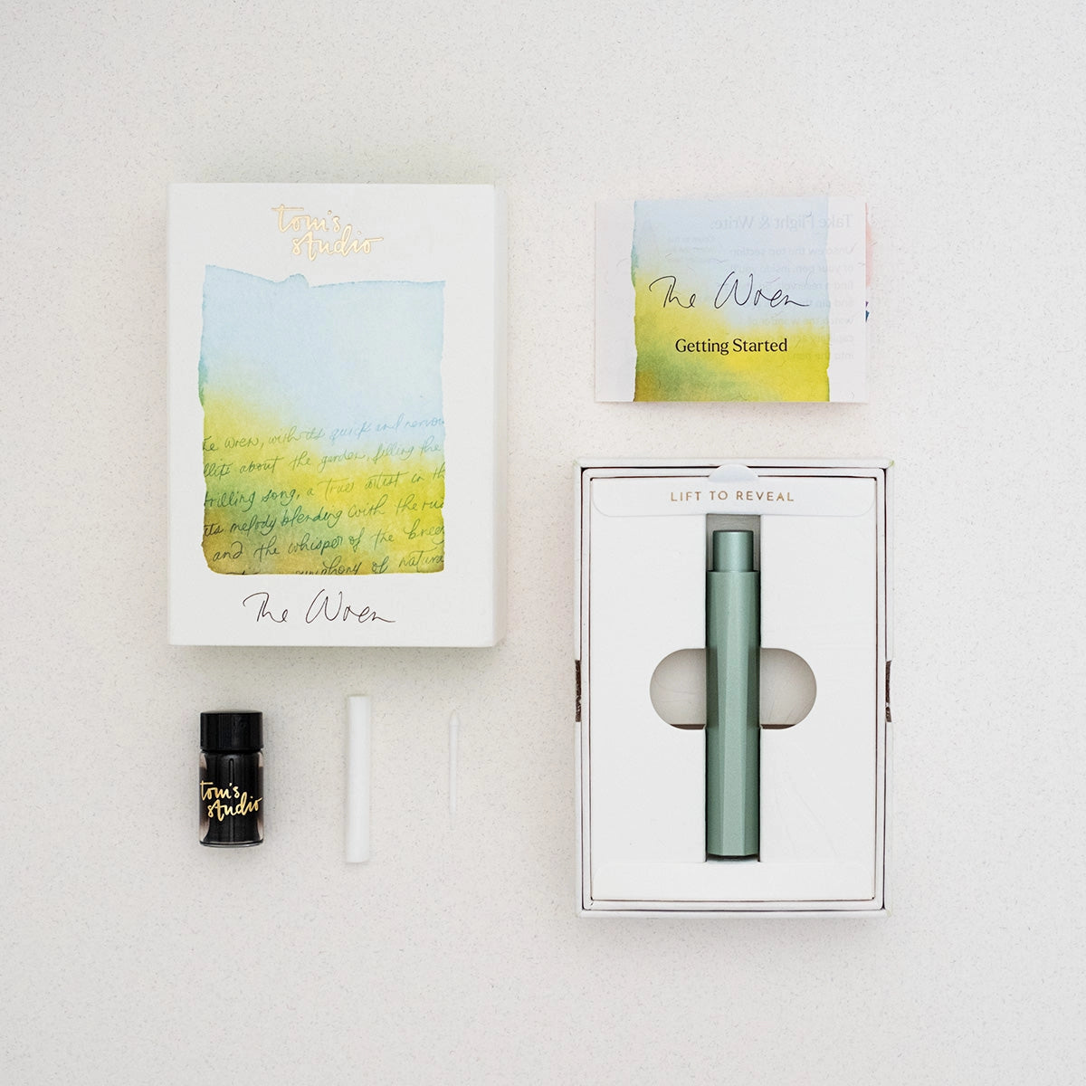 Tom’s Studio The Wren kit: refillable black pen, ink cartridge, vial, two sticks, card, and gift box—ideal calligraphy set.
