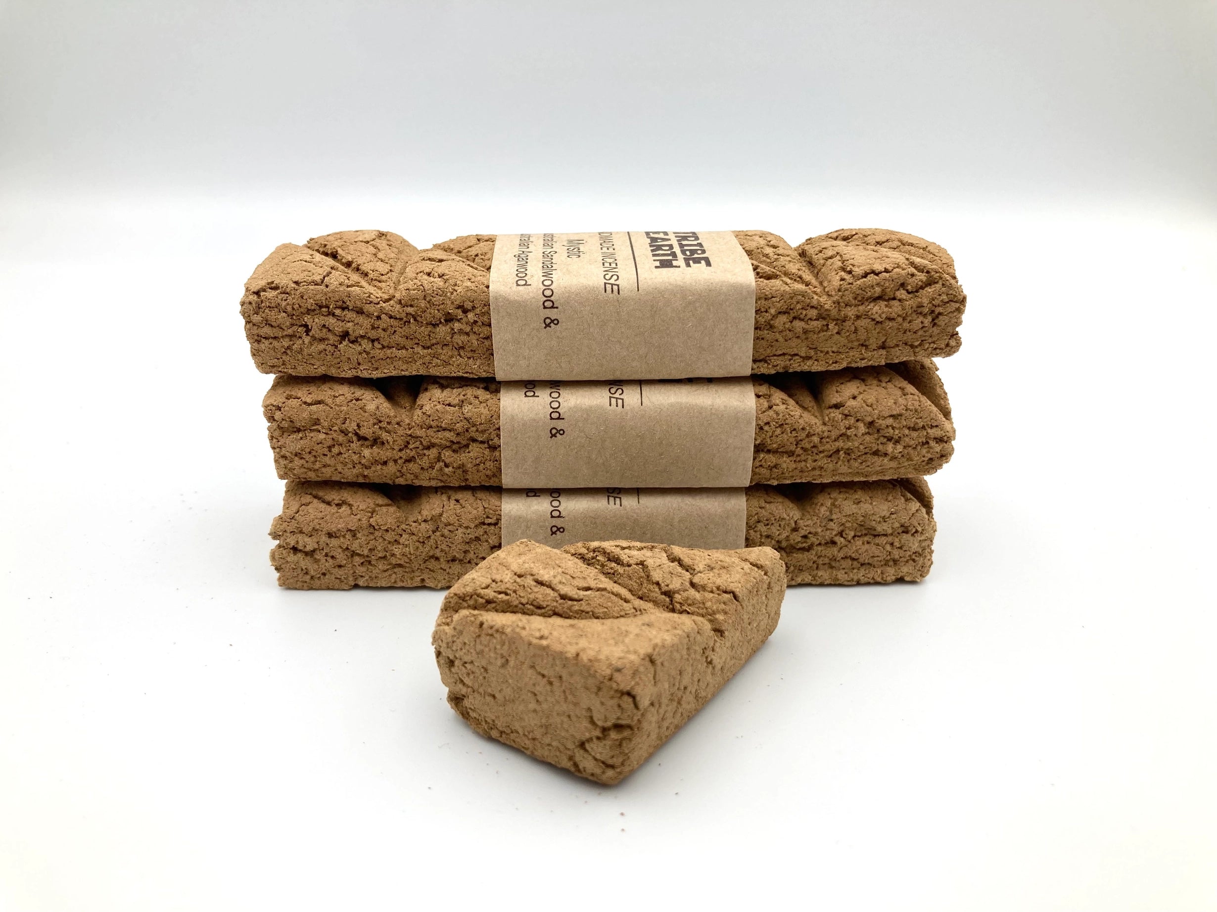 Four Tribe Earth Mystic incense plank bars, labeled, feature Australian Sandalwood & Agarwood aroma on white background.