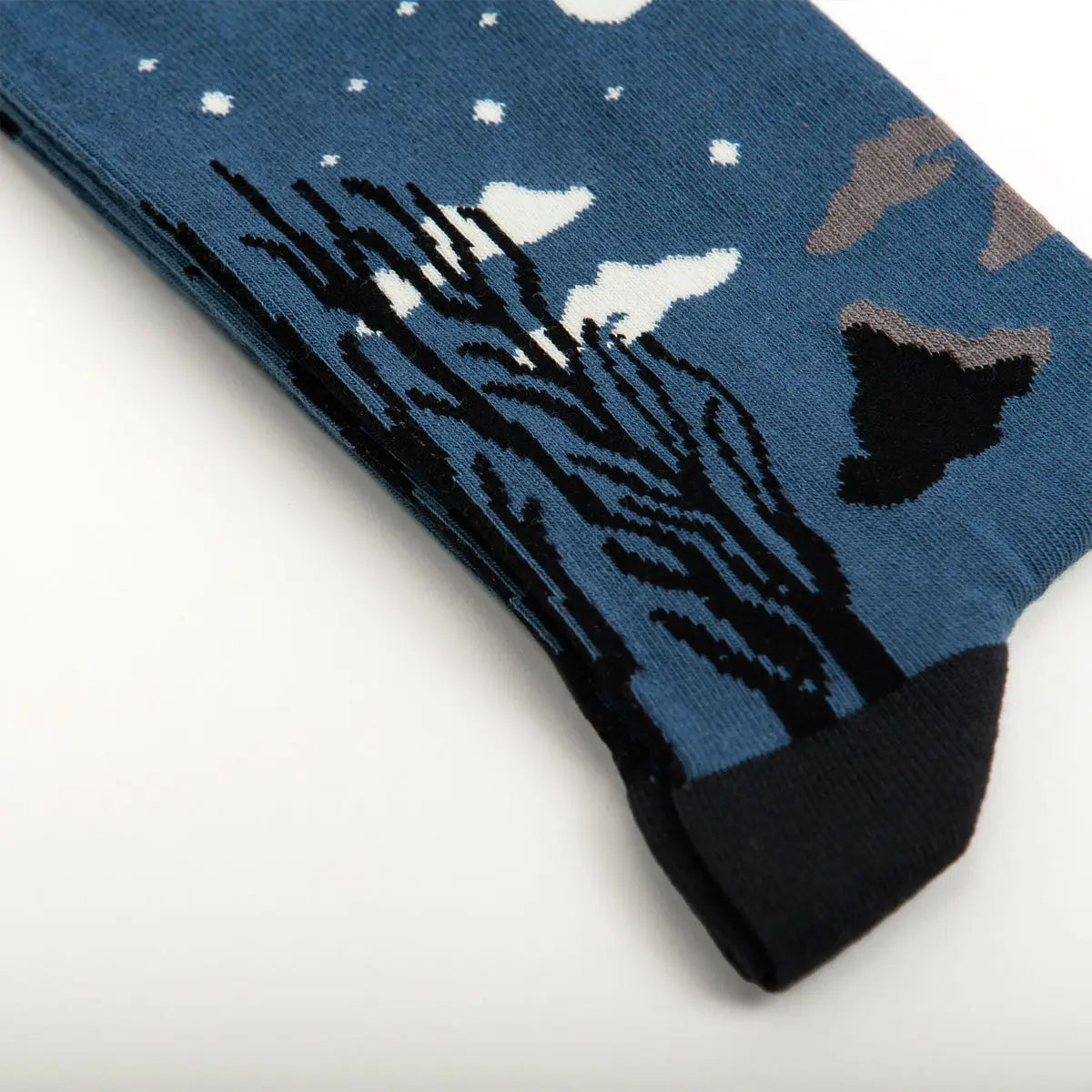 Close-up of Sock Affairs Carnival Evening Rousseau socks with trees, clouds, and stars in vibrant Henri Rousseau-inspired design.