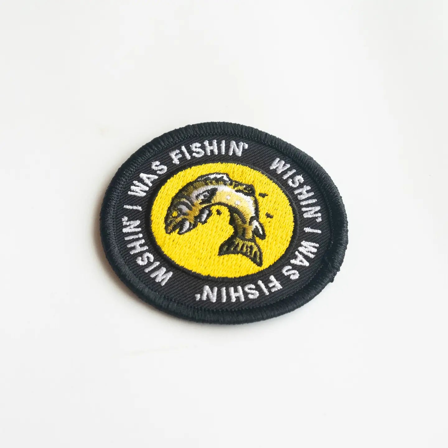 Union Made fishing patch: circular iron-on badge with a fish graphic, “Wishing I was Fishing” embroidered around the border.