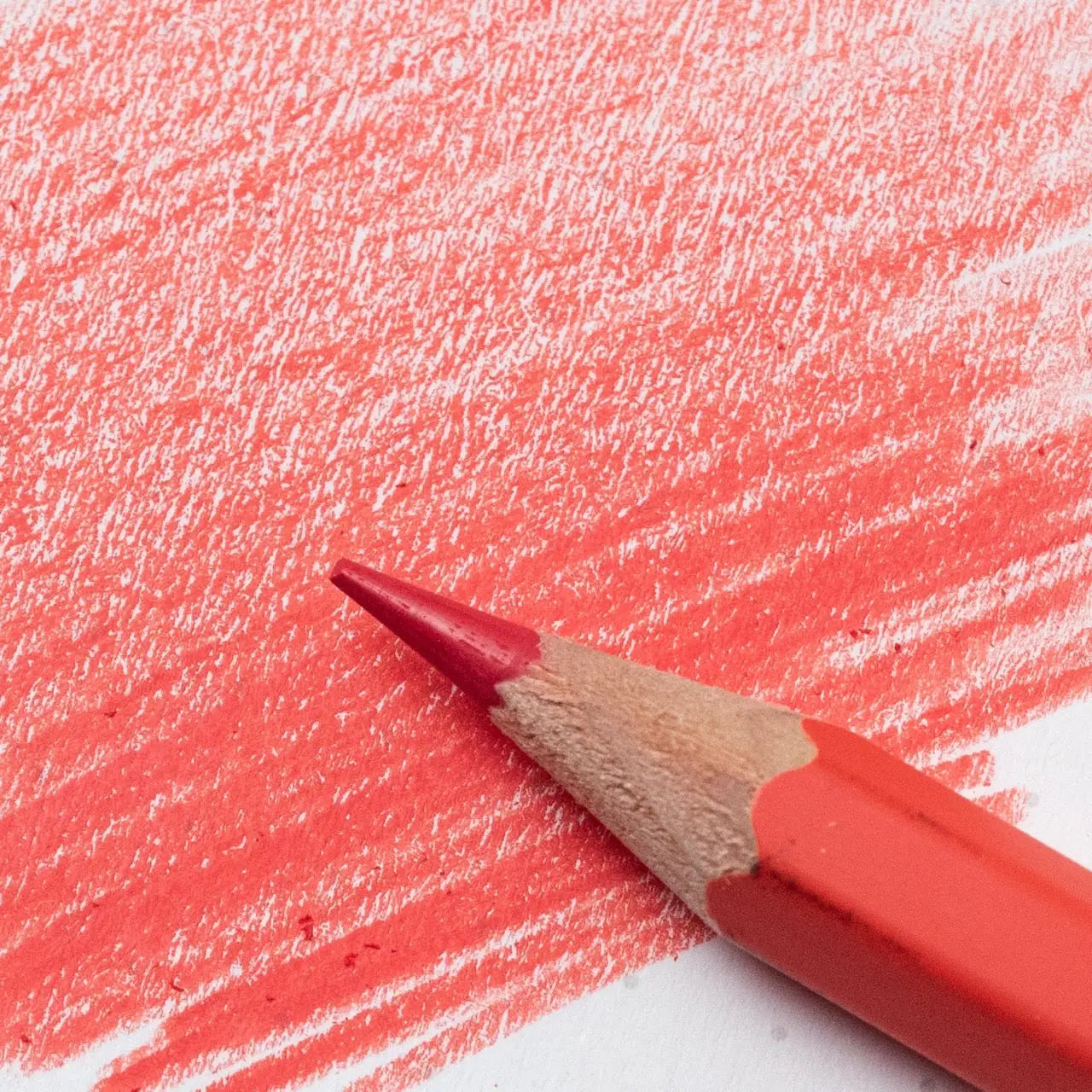 Blackwing Red pencil from a 6-pack draws vivid red marks on paper; premium art tool for artists, designers, and writers.