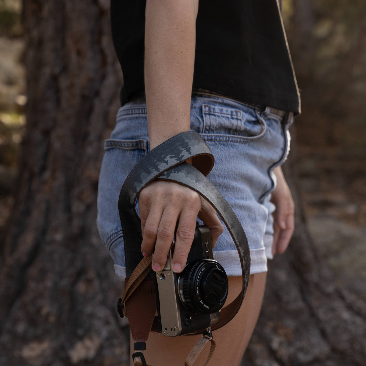 Forager Provisions LTD Wildtree Foggy Forest camera strap with mountain print and brown faux suede backing on a camera