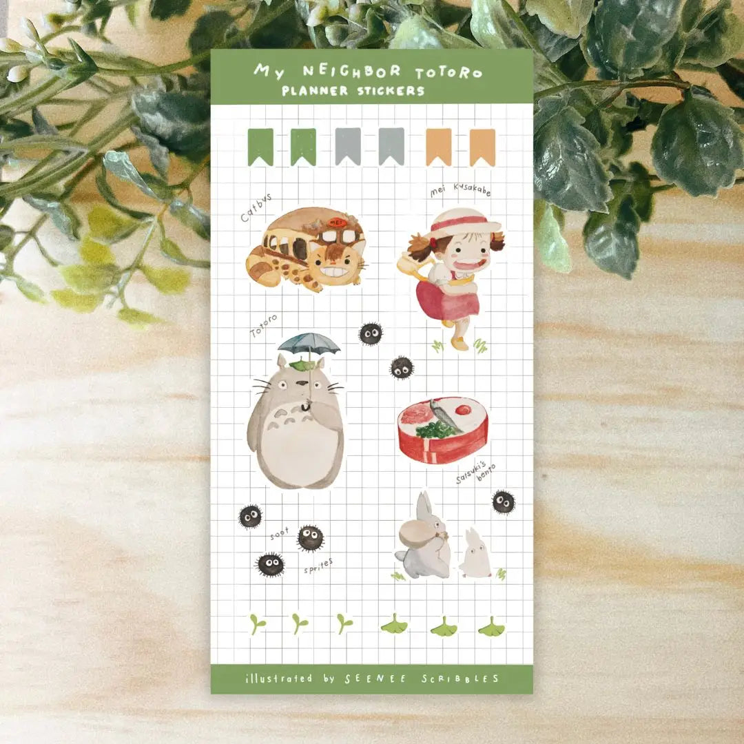The Seenee Scribbles Studio Ghibli Inspired Sticker Sheet - My Neighbour Totoro is perfect for bullet journaling and scrapbooking, showcasing beloved characters such as Totoro, Catbus, Soot Sprites, and more on a grid background. These stickers bring a touch of magic to your creative projects.