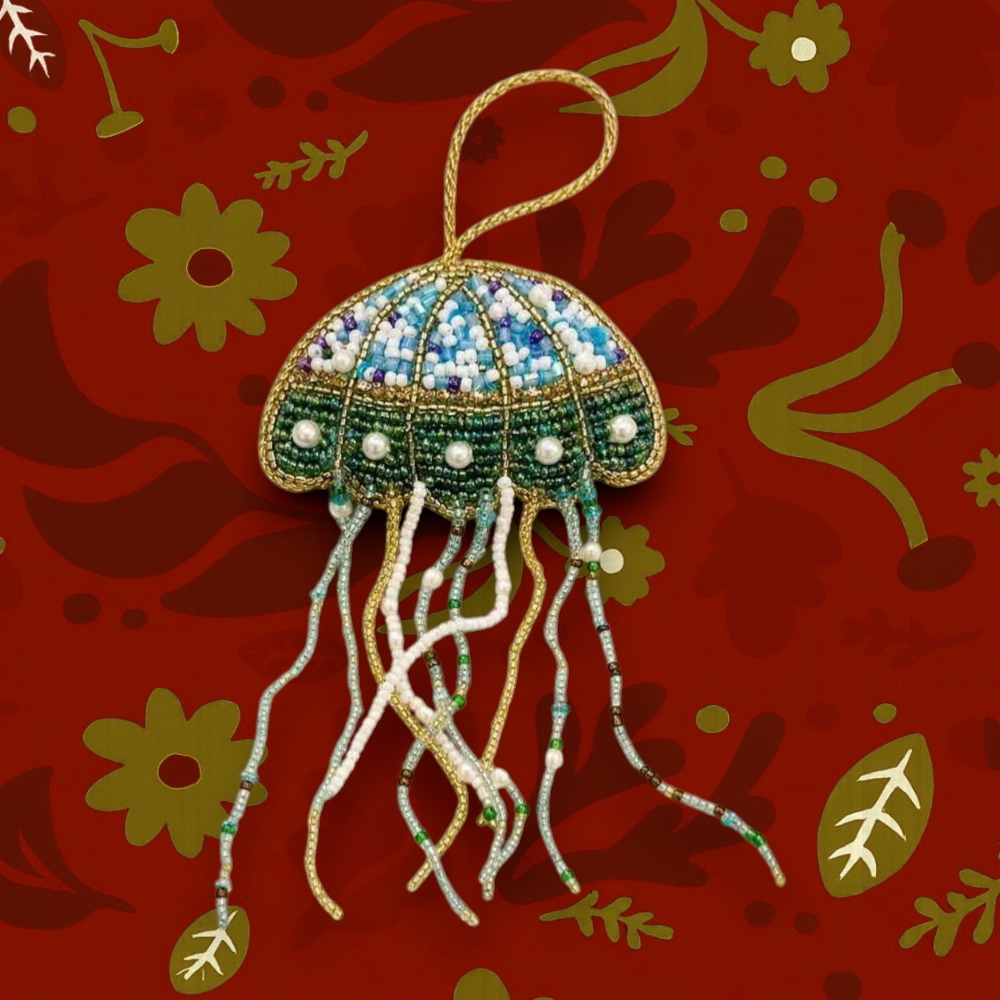 Forager Provisions LTD beaded jellyfish Christmas ornament with blue, green, and gold beads and dangling tentacles.