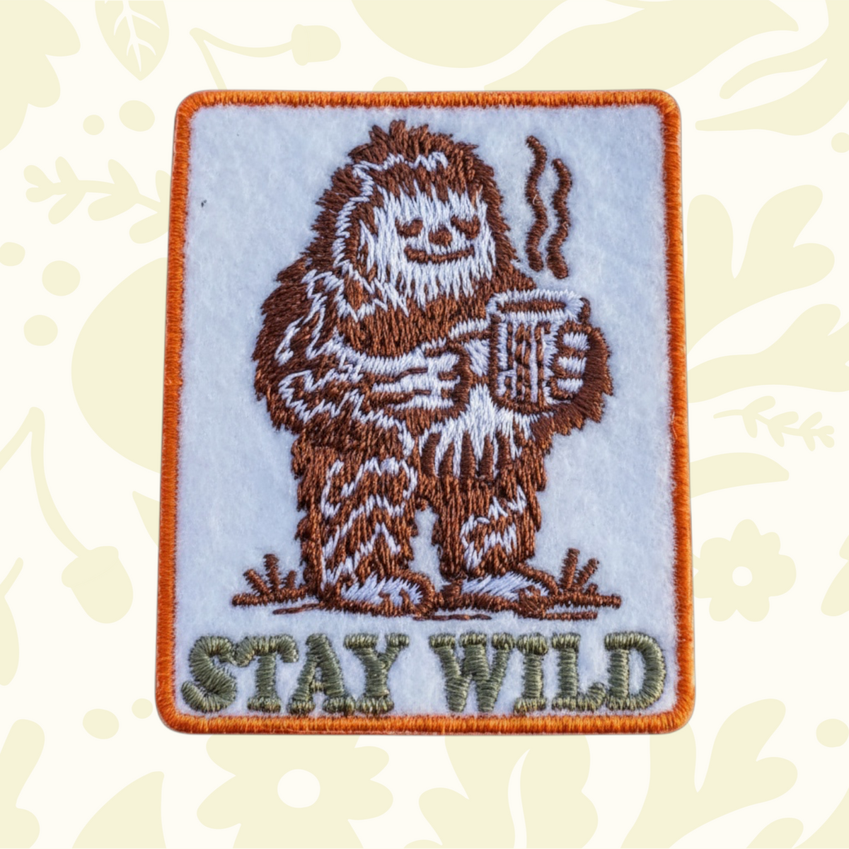 Forager Provisions LTD embroidered iron-on patch featuring a brown Bigfoot drinking coffee with Stay Wild text.