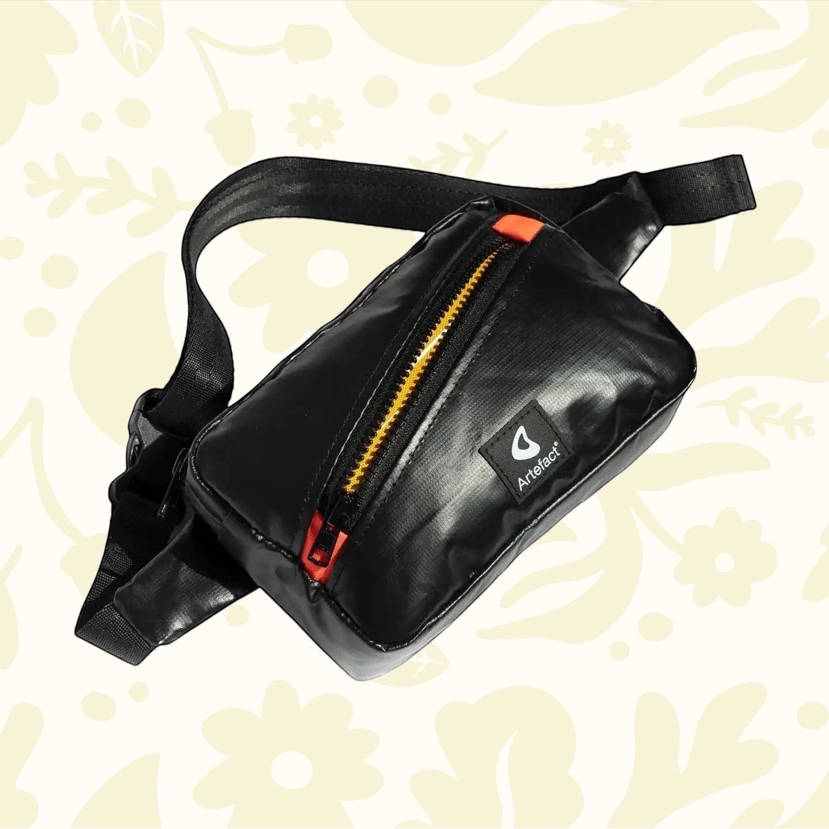 Forager Provisions LTD Artefact Eco black banana sling bag made from recycled lifeboat material with orange zip detail