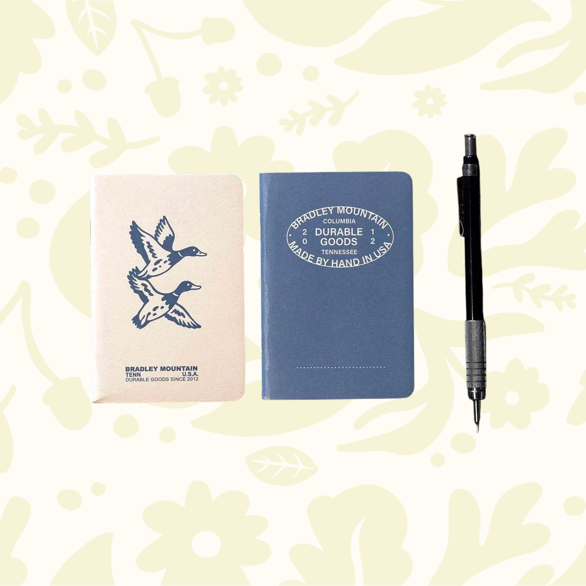 Forager Provisions LTD Bradley Mountain pocket journals in blue and cream with duck illustration on rustic wood table