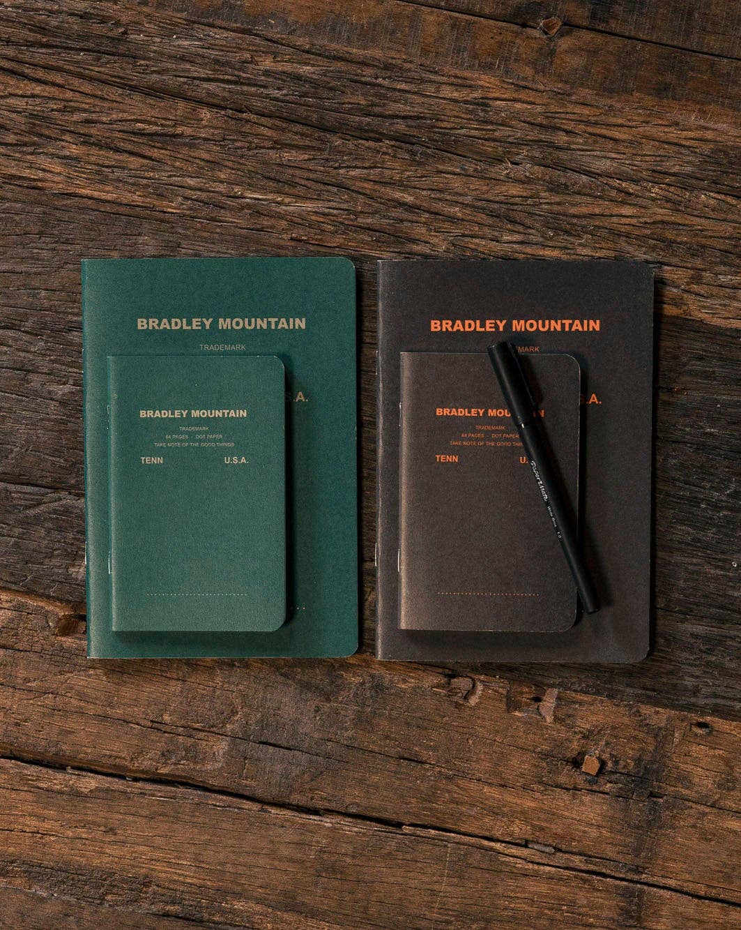 Forager Provisions LTD Bradley Mountain vintage-style large project journals in green and dark grey on a wooden surface.