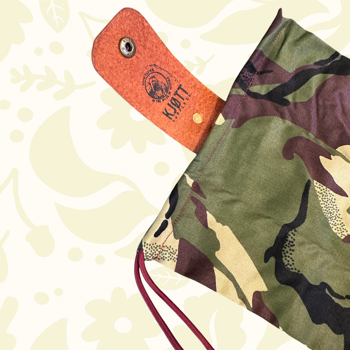 Forager Provisions LTD Kjøtt Supply Co camo forage pouch with leather popper closure and burgundy drawstring