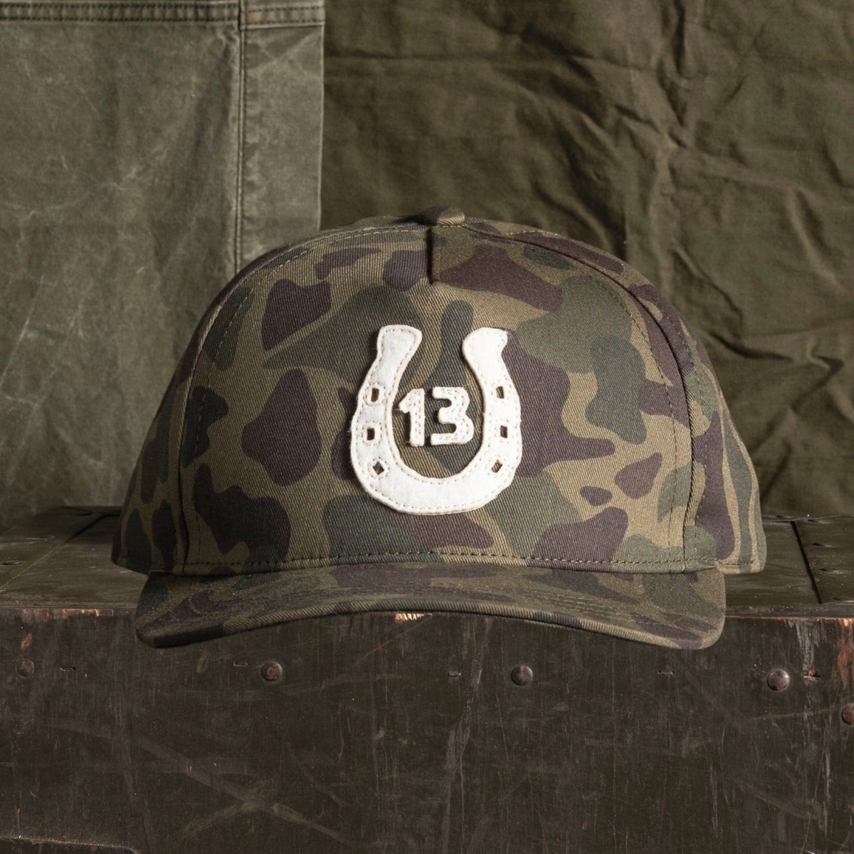 Forager Provisions LTD Bradley Mountain camo cotton twill cap with a white horseshoe 13 anniversary patch