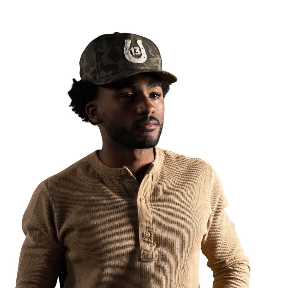 Forager Provisions LTD Bradley Mountain camo cotton twill cap with a raised 13 horseshoe patch worn by a man
